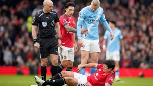 Harry Maguire dari Manchester United, di bagian bawah, tergeletak di lapangan kesakitan sementara wasit Anthony Taylor, Lisandro Martinez dari Manchester United, dan Erling Haaland dari Manchester City bereaksi selama pertandingan Liga Inggris antara Manchester United dan Manchester City di Manchester, Inggris, Sabtu, 17 Januari 2026.